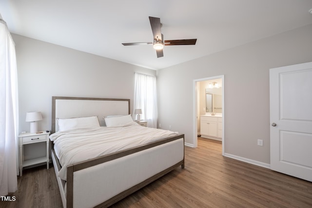 4524 Sweet Williams Ln NW, Wilson, NC 27896 - bedroom with baseboards, connected bathroom, ceiling fan, and wood finished floors