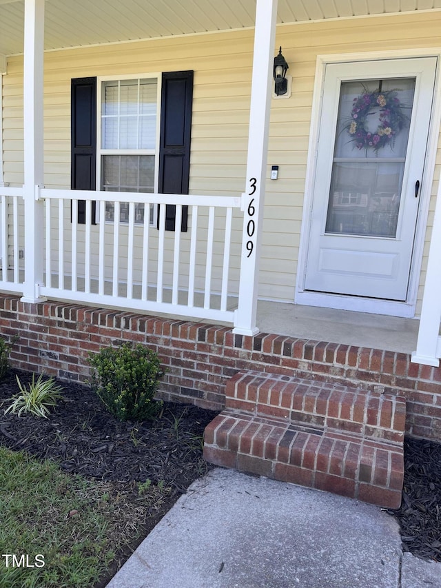 view of exterior entry with a porch