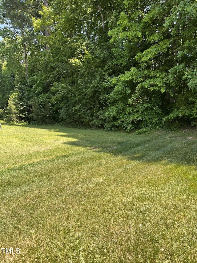 view of yard with a forest view
