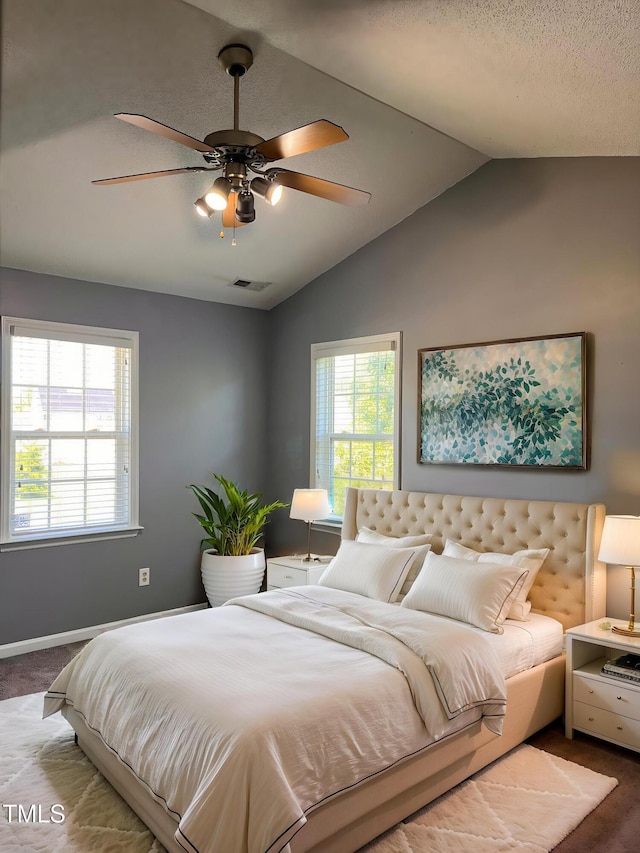 bedroom featuring ceiling fan, lofted ceiling, carpet floors, and visible vents