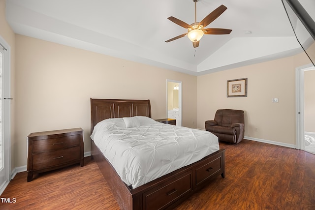 bedroom with dark wood-style flooring, baseboards, vaulted ceiling, a ceiling fan, and connected bathroom