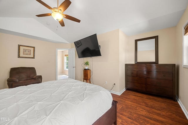 bedroom with vaulted ceiling, dark wood finished floors, baseboards, and a ceiling fan