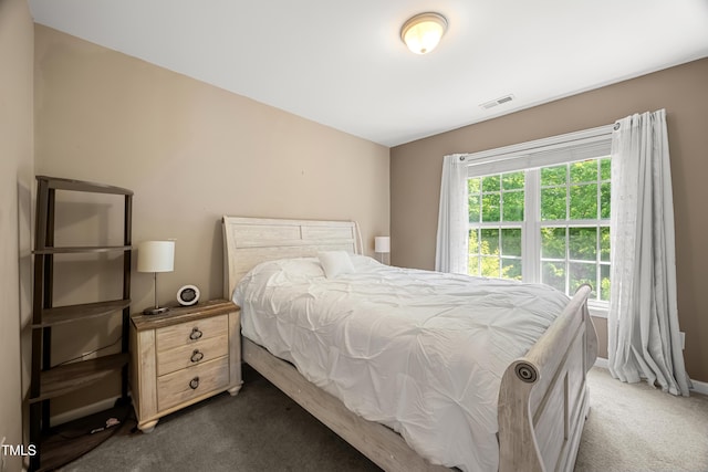 bedroom featuring dark carpet and baseboards