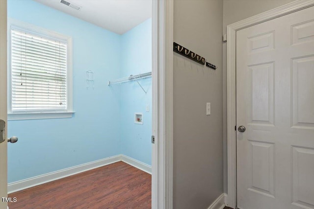 laundry room featuring dark wood-type flooring, baseboards, and hookup for a washing machine