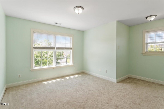 carpeted spare room with baseboards