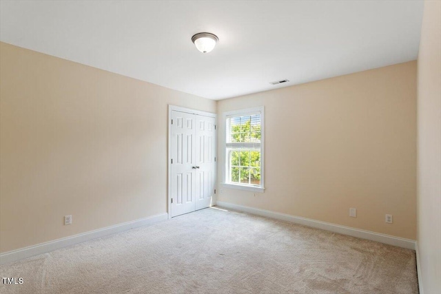 empty room with carpet floors and baseboards