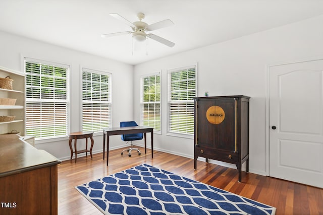 home office featuring wood finished floors, plenty of natural light, and ceiling fan