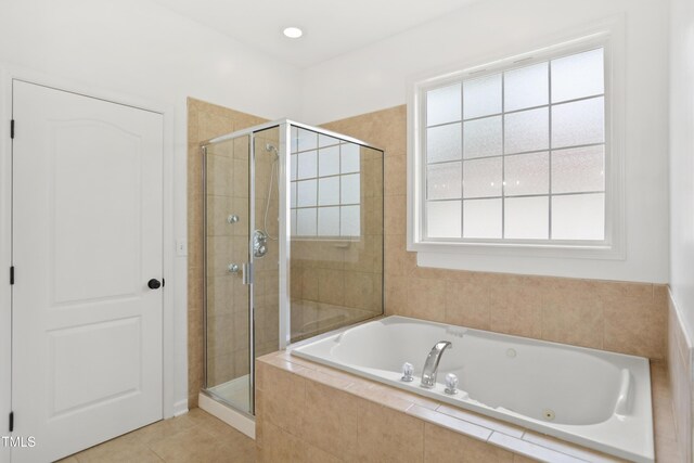 full bath featuring a shower stall, a whirlpool tub, and tile patterned floors