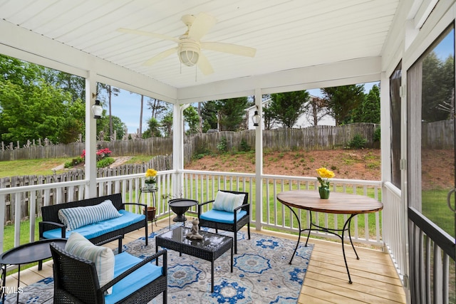 sunroom / solarium with ceiling fan, an outdoor living space, and plenty of natural light