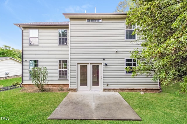 rear view of property with a yard and a patio