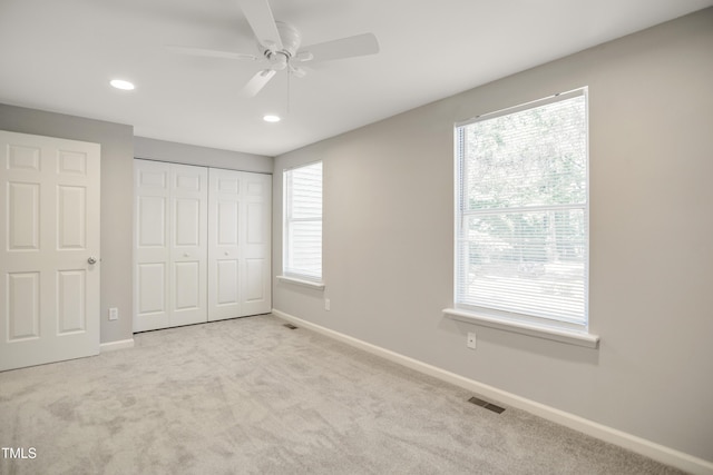 unfurnished bedroom featuring carpet floors, baseboards, a closet, recessed lighting, and a ceiling fan
