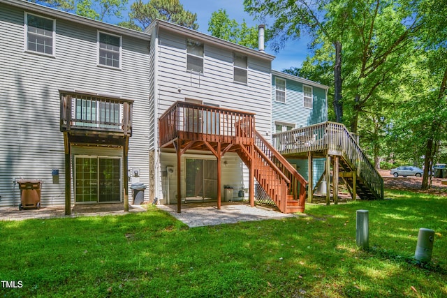 back of property featuring stairs, a yard, a patio, and a wooden deck