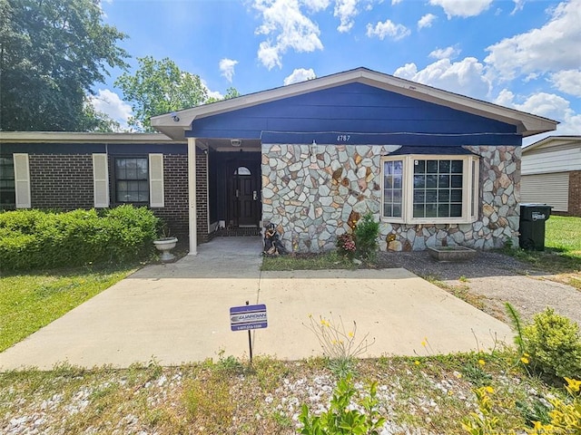 single story home with stone siding