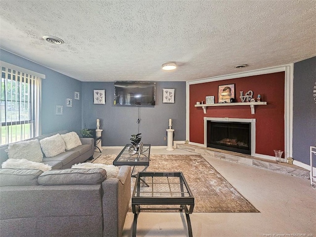 carpeted living room featuring a textured ceiling, a fireplace with raised hearth, baseboards, and visible vents
