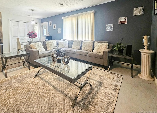 living room with a textured ceiling and visible vents