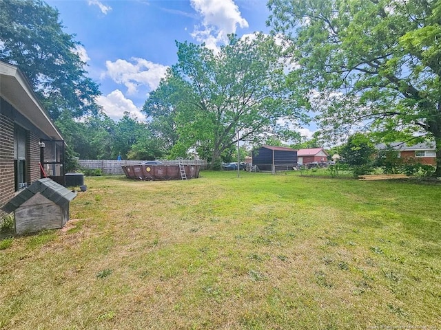 view of yard with fence and a fenced in pool