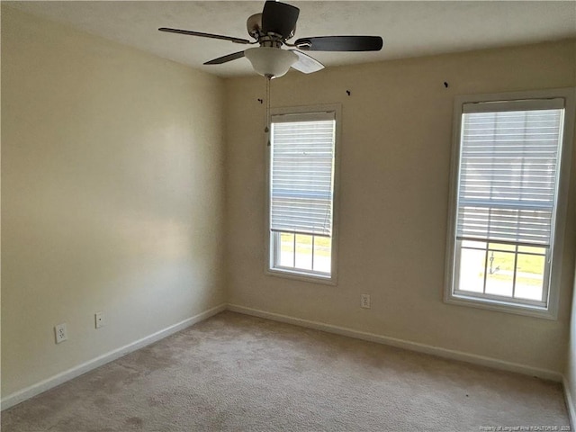spare room featuring carpet floors, baseboards, and a healthy amount of sunlight