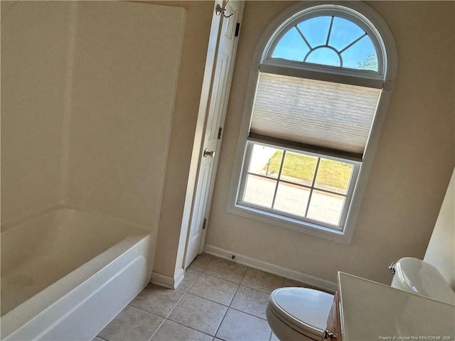 full bathroom featuring toilet, baseboards, and tile patterned flooring