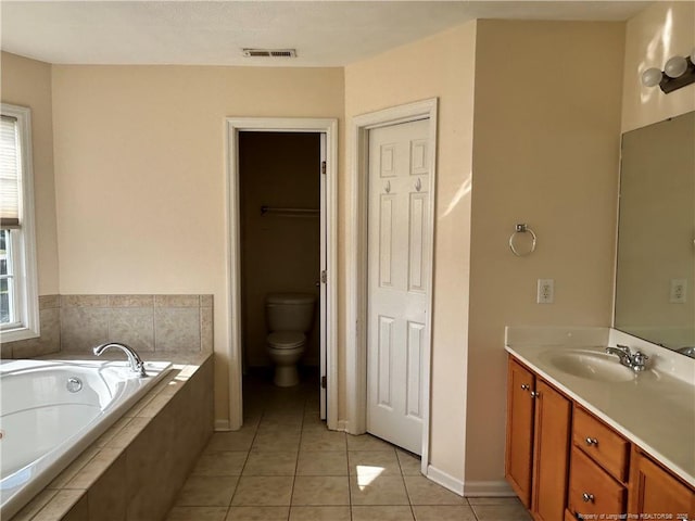 full bathroom with a healthy amount of sunlight, visible vents, tile patterned flooring, a garden tub, and vanity