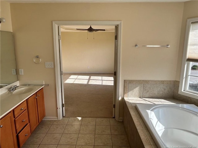 bathroom with tile patterned floors, vanity, a ceiling fan, and a garden tub