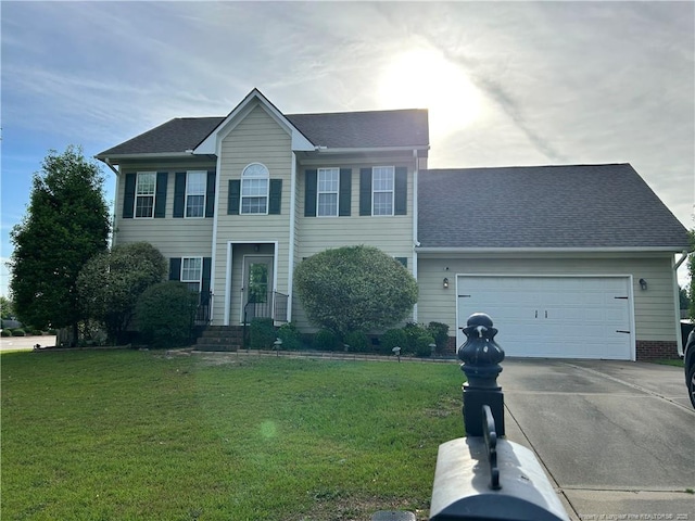 1901 Ellie Ave, Fayetteville, NC 28314 - colonial house featuring driveway, a front lawn, an attached garage, and roof with shingles