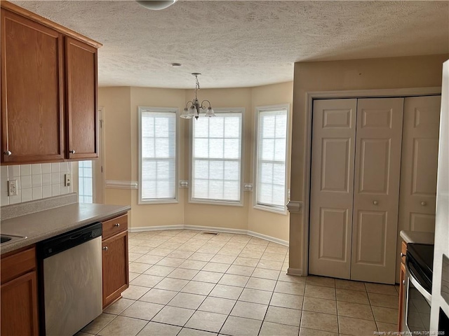 1901 Ellie Ave, Fayetteville, NC 28314 - kitchen with appliances with stainless steel finishes, brown cabinetry, a chandelier, tasteful backsplash, and light tile patterned flooring