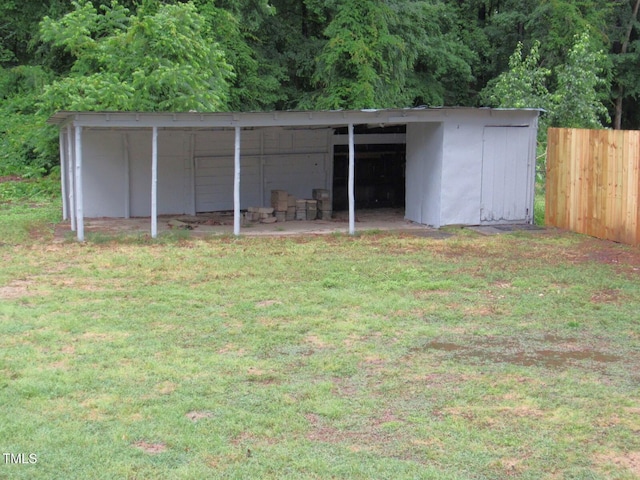 view of pole building featuring fence and a lawn