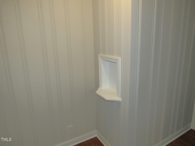 interior details featuring baseboards and wood finished floors