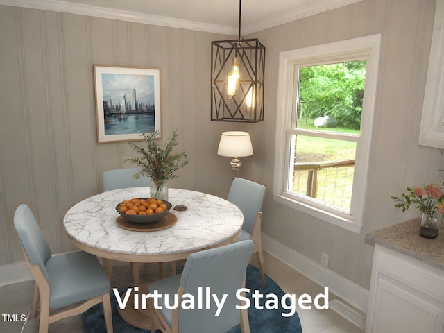 dining area featuring crown molding, plenty of natural light, and baseboards