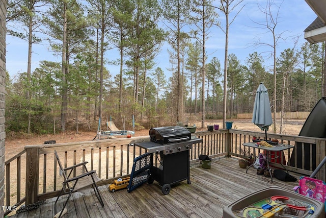 wooden terrace featuring grilling area