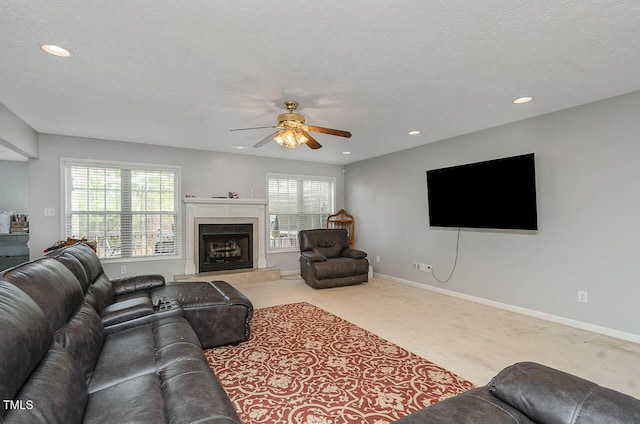 living area featuring a fireplace, carpet floors, a ceiling fan, and recessed lighting