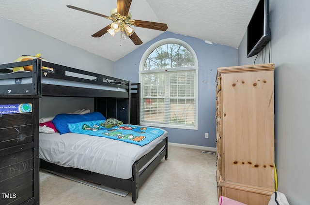 carpeted bedroom featuring a textured ceiling, vaulted ceiling, baseboards, and ceiling fan