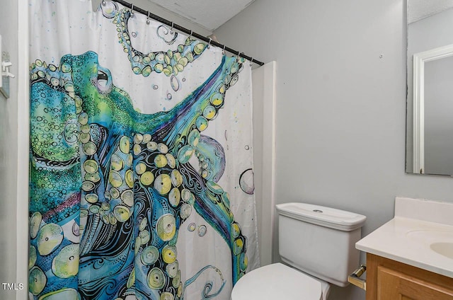 bathroom featuring vanity, toilet, a textured ceiling, and a shower with curtain
