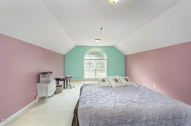 carpeted bedroom featuring lofted ceiling, baseboards, visible vents, and a textured ceiling