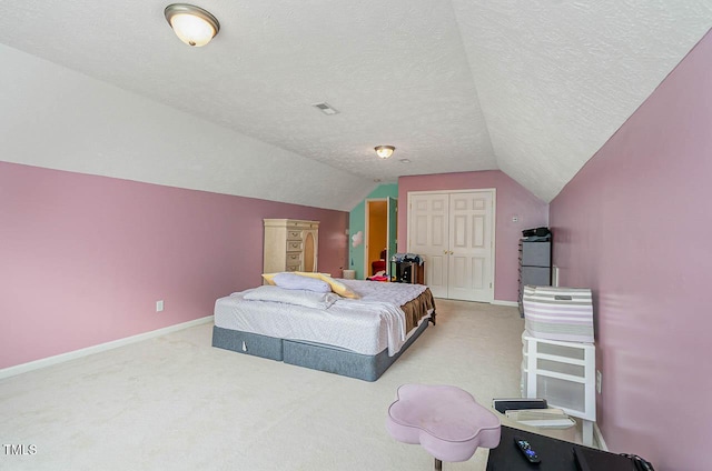 carpeted bedroom featuring vaulted ceiling, a textured ceiling, baseboards, and a closet