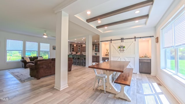 2912 Epps Clark Rd, Siler City, NC 27344 - dining space featuring a barn door, plenty of natural light, a ceiling fan, and light wood-style flooring