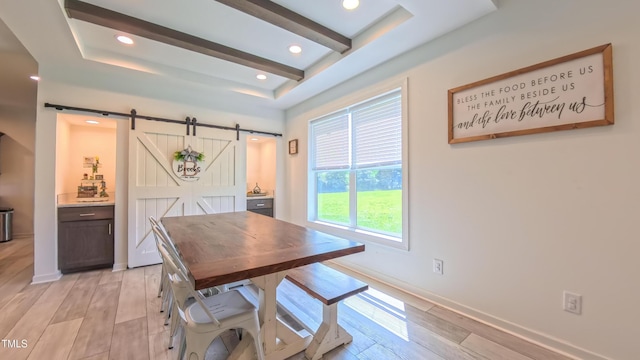 2912 Epps Clark Rd, Siler City, NC 27344 - dining area featuring a barn door, light wood-type flooring, beam ceiling, baseboards, and a tray ceiling