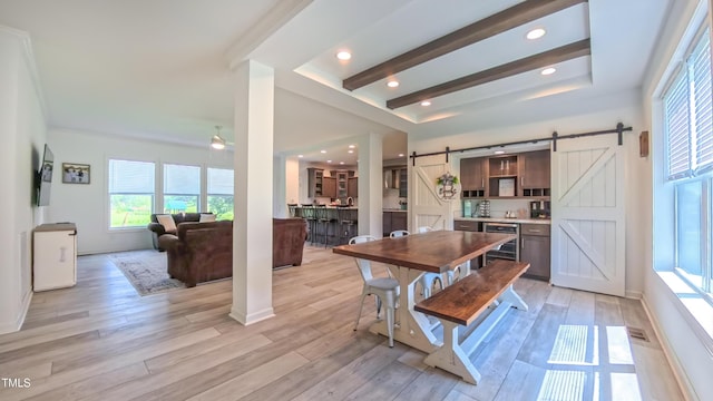 2912 Epps Clark Rd, Siler City, NC 27344 - dining space with a barn door, light wood-style flooring, a tray ceiling, and beverage cooler