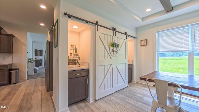 2912 Epps Clark Rd, Siler City, NC 27344 - dining room featuring a barn door, light wood-type flooring, recessed lighting, and baseboards