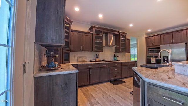 2912 Epps Clark Rd, Siler City, NC 27344 - kitchen with wall chimney range hood, stainless steel appliances, backsplash, light wood-type flooring, and glass insert cabinets