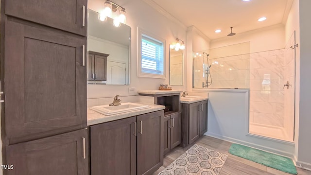 2912 Epps Clark Rd, Siler City, NC 27344 - full bathroom featuring tiled shower, crown molding, two vanities, wood finished floors, and recessed lighting