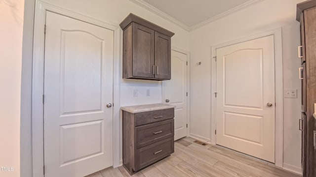 2912 Epps Clark Rd, Siler City, NC 27344 - interior space featuring crown molding, light wood-style flooring, light countertops, and dark brown cabinetry