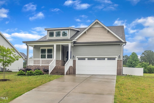 9 Little Sunshine Brk, Smithfield, NC 27577 - craftsman house featuring covered porch, driveway, brick siding, and a front lawn