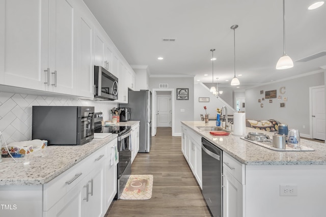 9 Little Sunshine Brk, Smithfield, NC 27577 - kitchen with appliances with stainless steel finishes, a sink, ornamental molding, recessed lighting, and white cabinetry