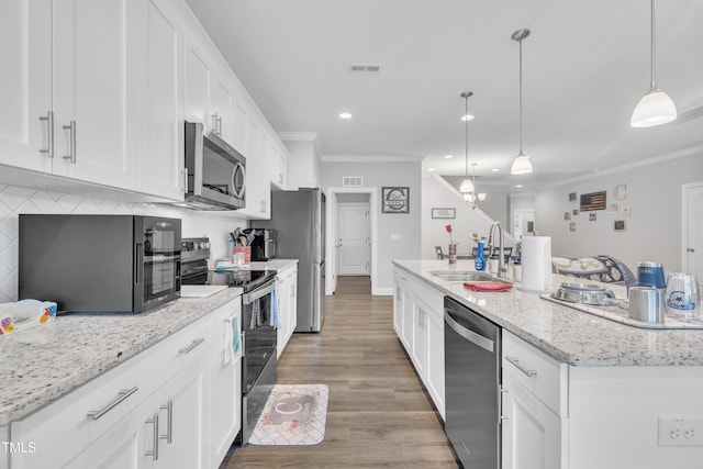 9 Little Sunshine Brk, Smithfield, NC 27577 - kitchen with stainless steel appliances, a sink, ornamental molding, white cabinetry, and a kitchen island with sink