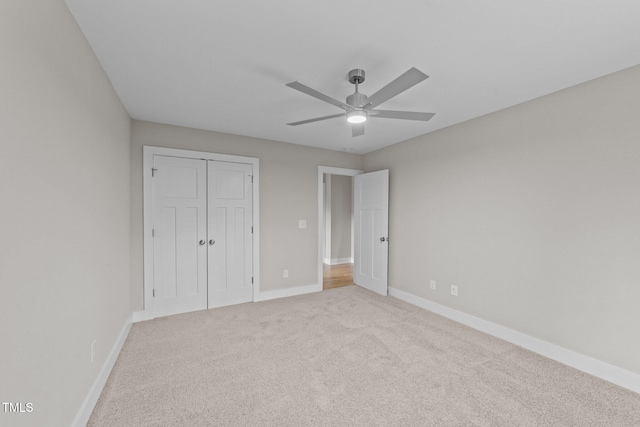 unfurnished bedroom with baseboards, carpet flooring, a closet, and ceiling fan