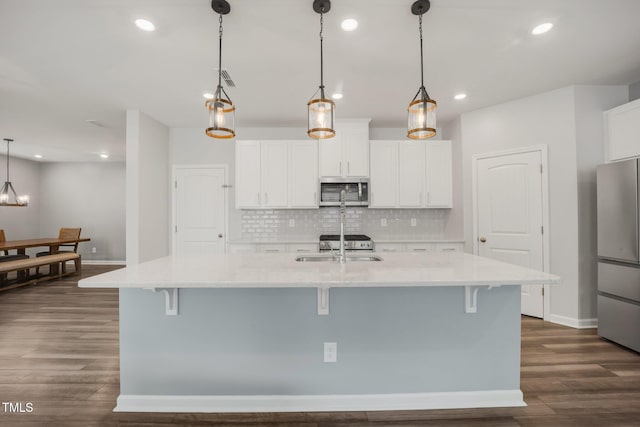 712 Emmer St, Rolesville, NC 27571 - kitchen with stainless steel appliances, decorative backsplash, baseboards, dark wood finished floors, and a breakfast bar