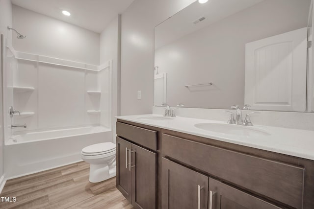 712 Emmer St, Rolesville, NC 27571 - bathroom with toilet, double vanity, wood finished floors, shower / bathtub combination, and recessed lighting