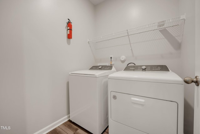 712 Emmer St, Rolesville, NC 27571 - washroom featuring washer and clothes dryer, wood finished floors, and baseboards