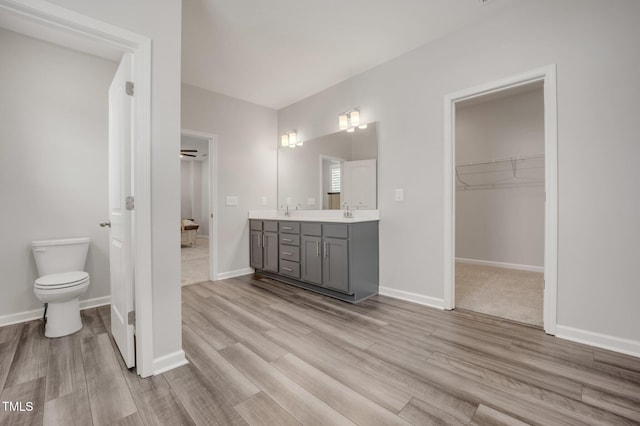 712 Emmer St, Rolesville, NC 27571 - full bath featuring double vanity, a spacious closet, toilet, wood finished floors, and baseboards